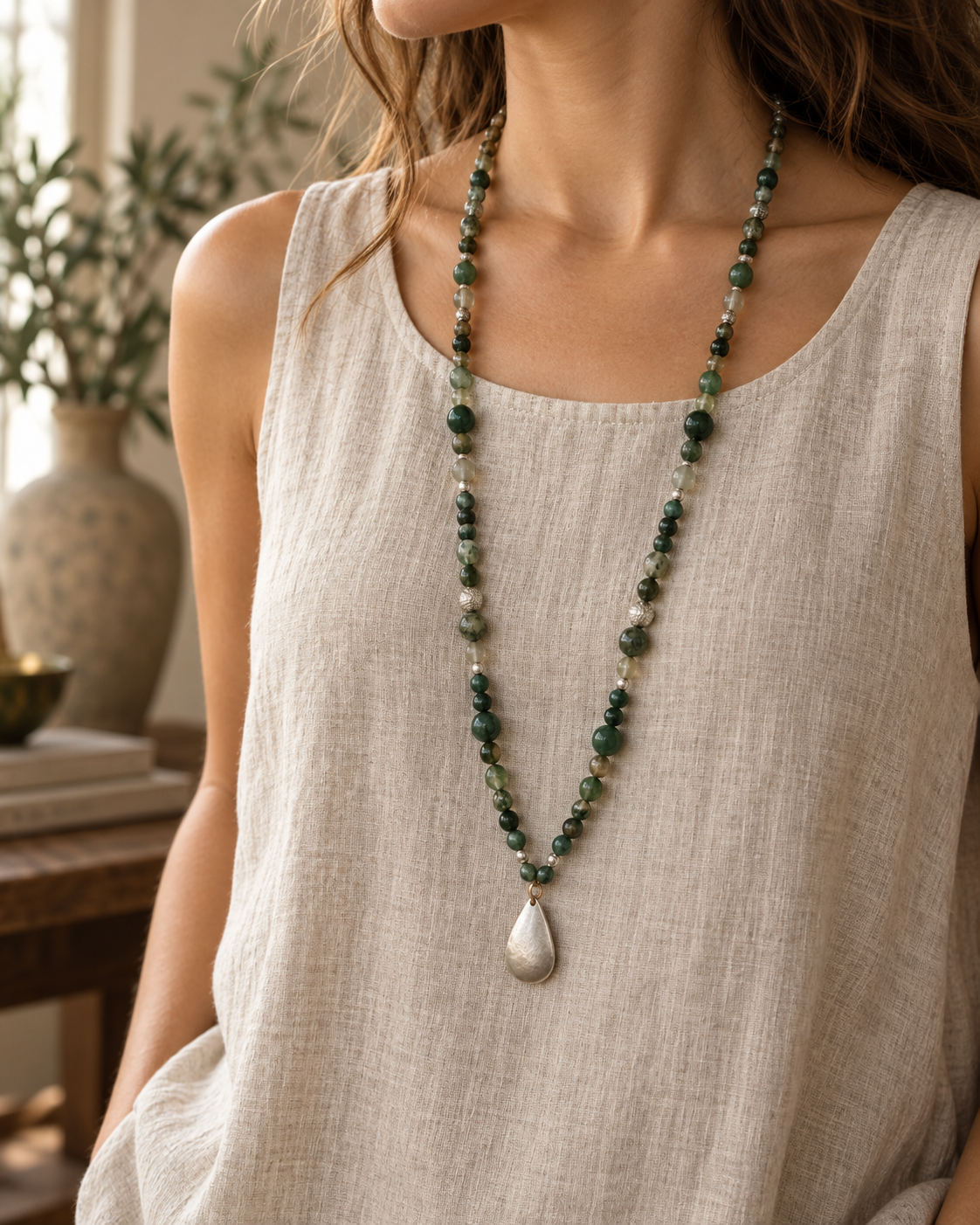 Long green stone necklace with matte silver teardrop pendant
