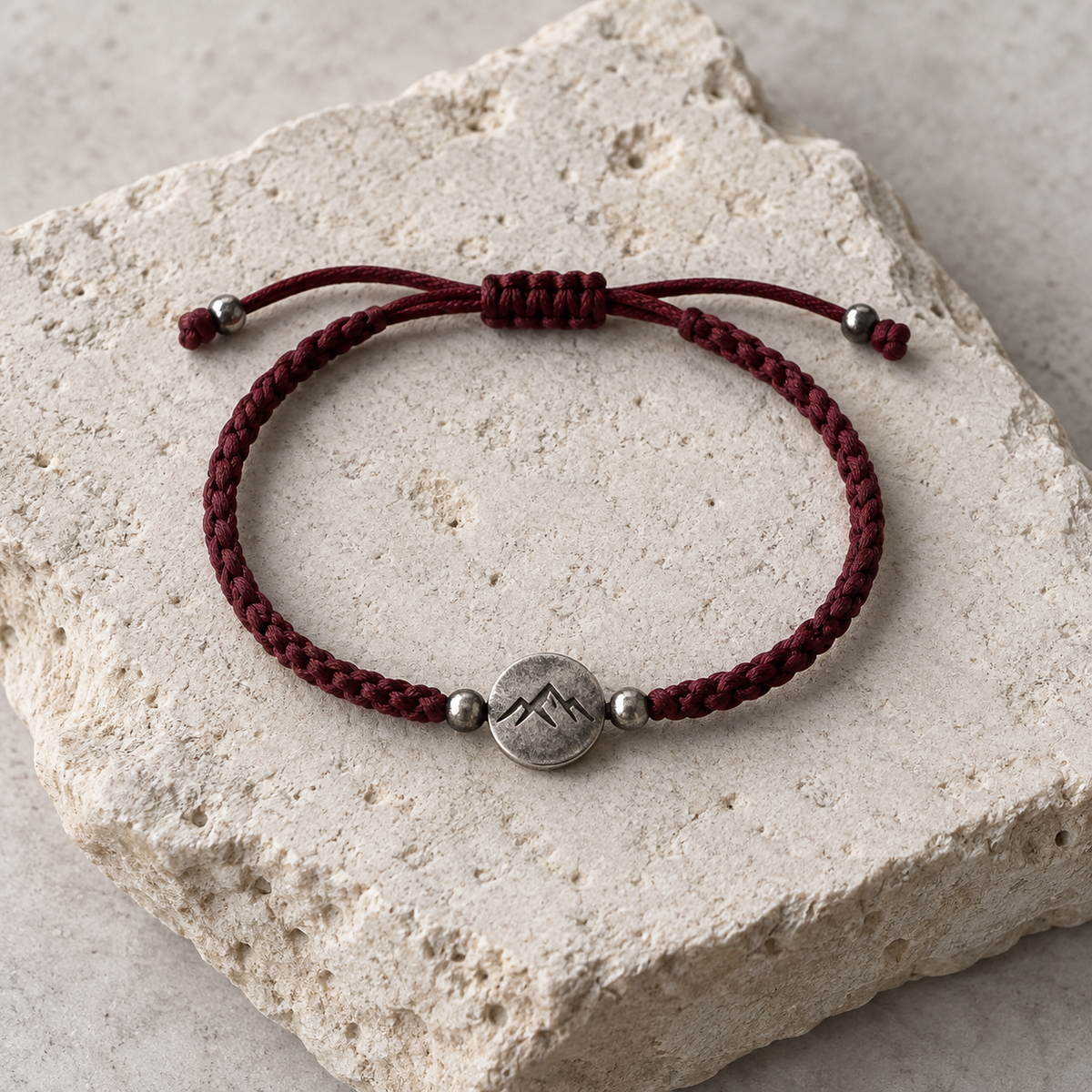 Red cord intention bracelet with a warm stone centerpiece